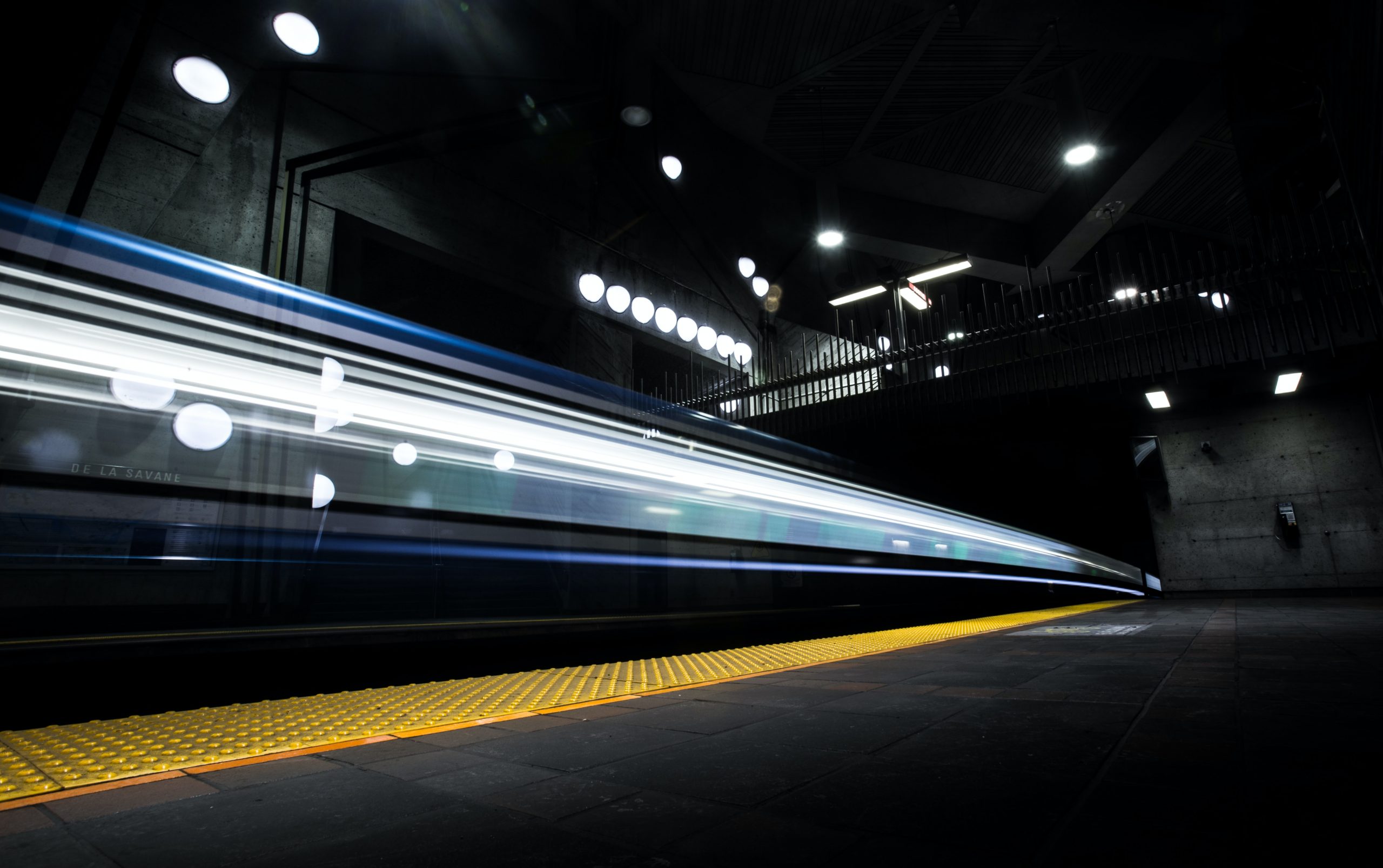 A Montreal Metro train passes through De La Savane station. Photo by William Daigneault.